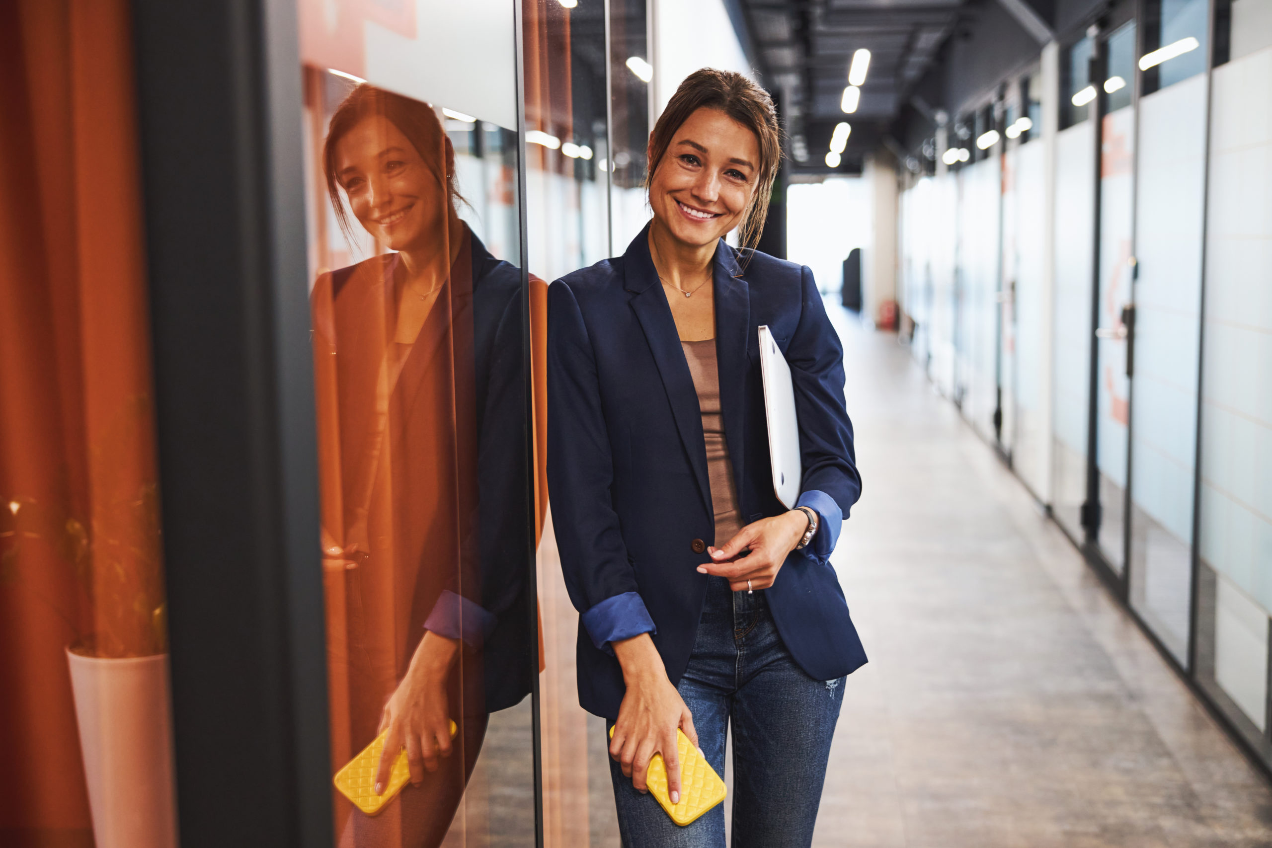 Charming happy smiling female consultant posing and looking at the photo camera